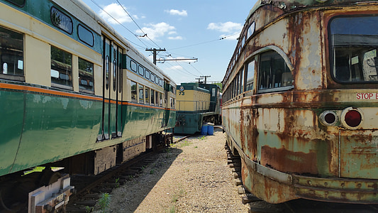 photo of two white-and-teal trains thumbnail