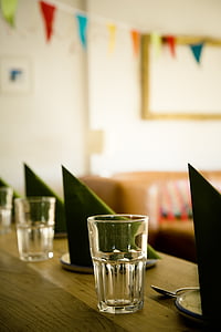 three clear drinking glasses on table thumbnail