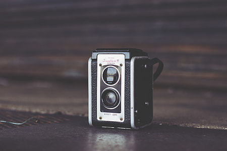 vintage black and white camera on black surface thumbnail