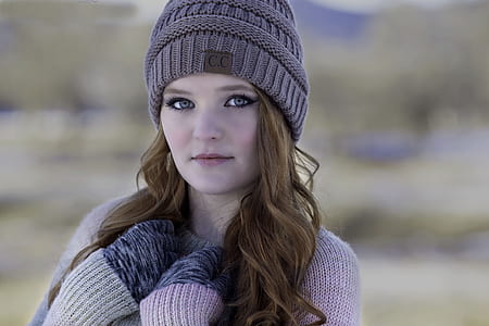 woman wears brown knitted hat thumbnail