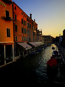 boat on body of water near houses thumbnail