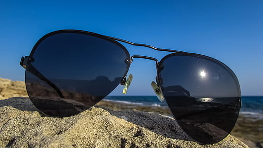 black aviator sunglasses on gray sand thumbnail