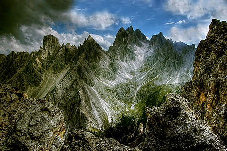 mountain covered with trees under cloudy sky thumbnail