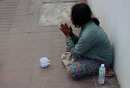 person sitting near wall thumbnail