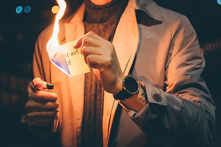 person burning paper holding disposable lighter thumbnail