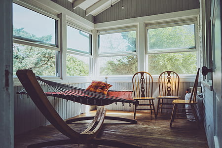 three brown wooden framed windsor chairs near brown hammock thumbnail