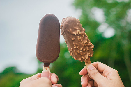 person holding two popsicles thumbnail