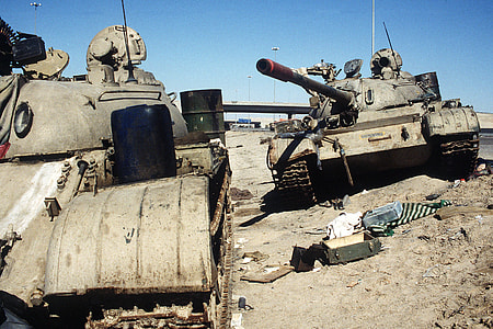Two Iraqi tanks lie abandoned near Kuwait City in Gulf War thumbnail