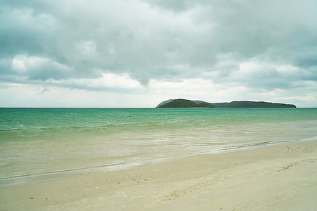 calm ocean near island thumbnail