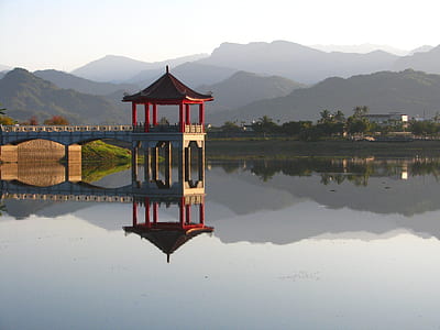 red and gray gazebo on body of water during daytime thumbnail