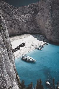 white boat docked near beach thumbnail