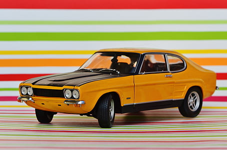 closeup photography of orange and black Ford Torino die-cast metal model thumbnail