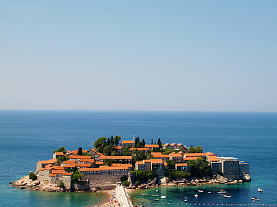 island with concrete buildings under blue sky thumbnail