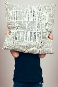 person covering face with white and black printed pillow thumbnail
