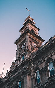 brown concrete building under blue sky thumbnail