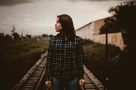 shallow focus photography of woman on train railway thumbnail
