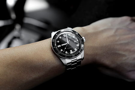 round black and silver-colored analog watch with link straps at 9:02 thumbnail