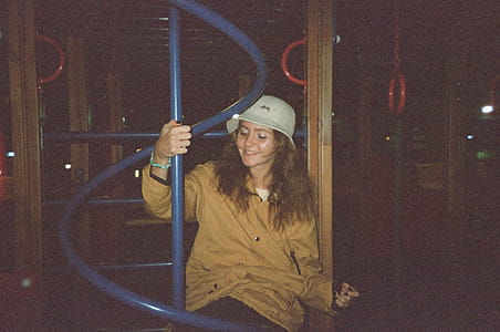 Woman Sitting on Blue Metal Playground thumbnail