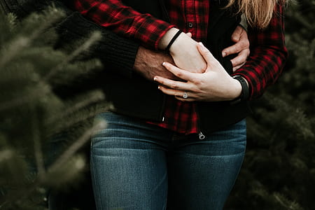 man and woman hugging near plants thumbnail