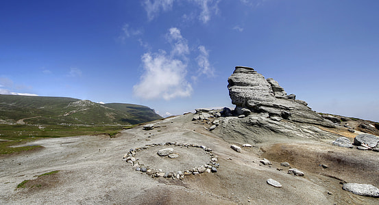 gray rock formation under blue sky thumbnail