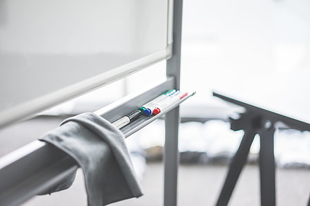 Colored Whiteboard Markers on Whiteboard Marker Tray in Office thumbnail