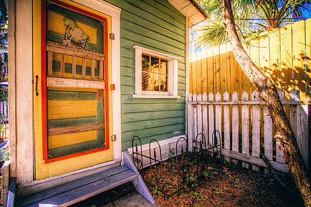 green, orange, and red wooden painted house thumbnail