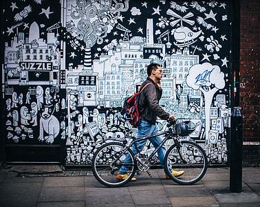 man walking beside wall art thumbnail