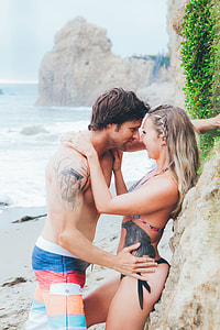 man and woman facing each other on shore thumbnail
