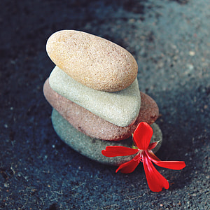 four stones on gray surface at daytime thumbnail