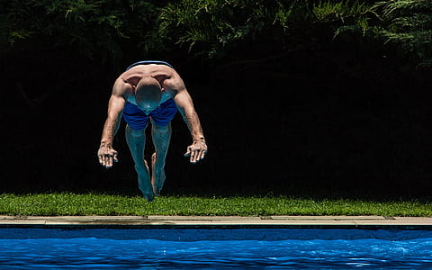man about to dive in swimming pool during daytime thumbnail