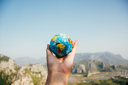 person holding blue globe thumbnail