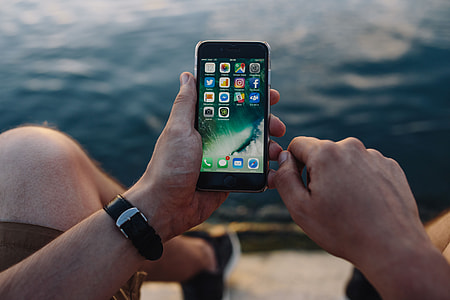 Mobile phone in man's hands near the sea thumbnail