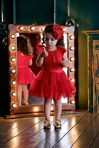 girl wearing red cap-sleeved dress holding lipstick thumbnail