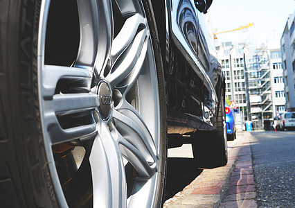 black Audi vehicle parked on sidewalk thumbnail
