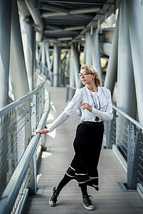 woman standing on hallway looking at right side during daytime thumbnail