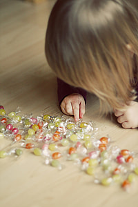 selective focus photography of girl touching beads on top of floor thumbnail