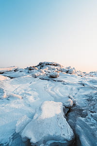 landscape photography of snow coated rocks on ground thumbnail