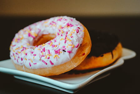 two doughnuts on white ceramic plate thumbnail