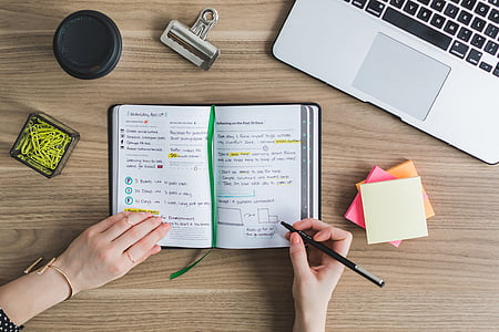 person holding writing on notebook thumbnail