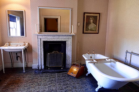 white clawfoot bathtub near fireplace thumbnail