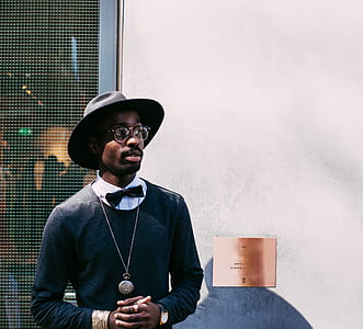 man looking to his left wearing black hat thumbnail