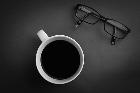 black framed eyeglasses beside white ceramic mug thumbnail