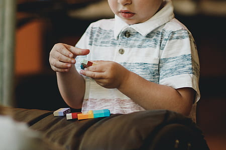 boy wearing white and gray polo shirt thumbnail