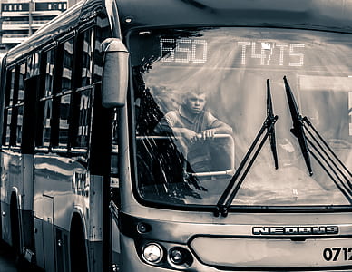 man standing inside bus thumbnail
