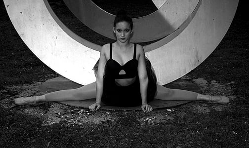 grayscale photo of woman performing gymnastics thumbnail