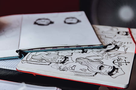 shallow focus photography of white sketch pad with drawing thumbnail