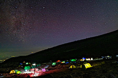 aerial photography of lighted camping tents under gray sky during nighttime thumbnail