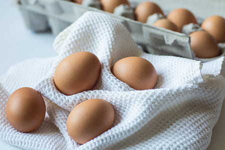 photo of brown eggs with trays near white textile thumbnail