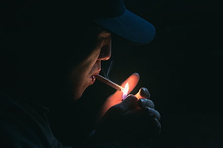 close-up photography of person lighting cigarette thumbnail