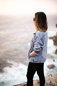 woman facing body of water thumbnail